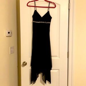 Small , will fit a size 2-4. Black with silver beading under breast.
